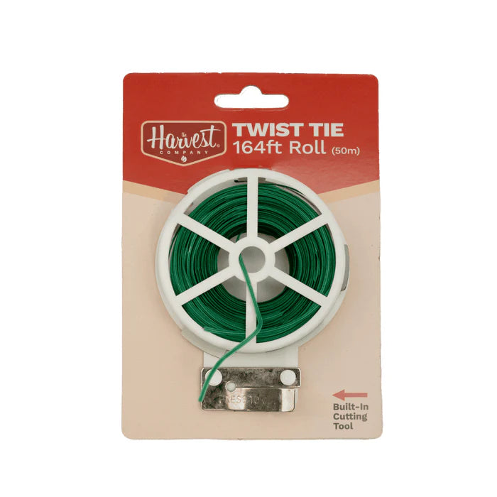 Green twist tie roll with packaging on a white background