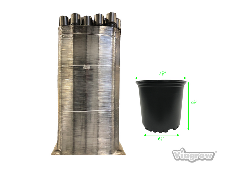 A stack of black plastic nursery pots with visible dimensions next to a wrapped pallet.