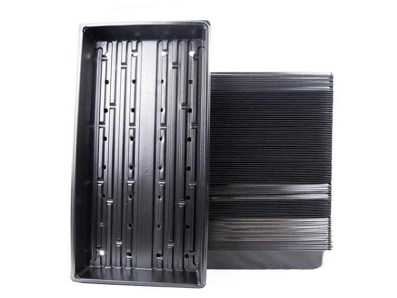 A stack of black plastic garden growing trays with drain holes.