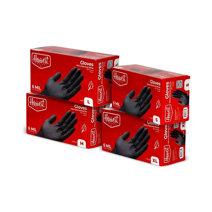 Four boxes of Harvest gloves on a white background